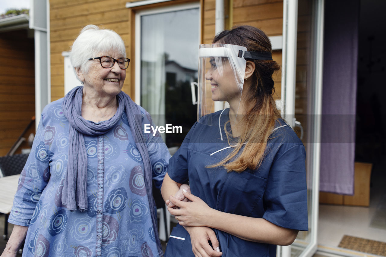 Nurse walking with elderly woman