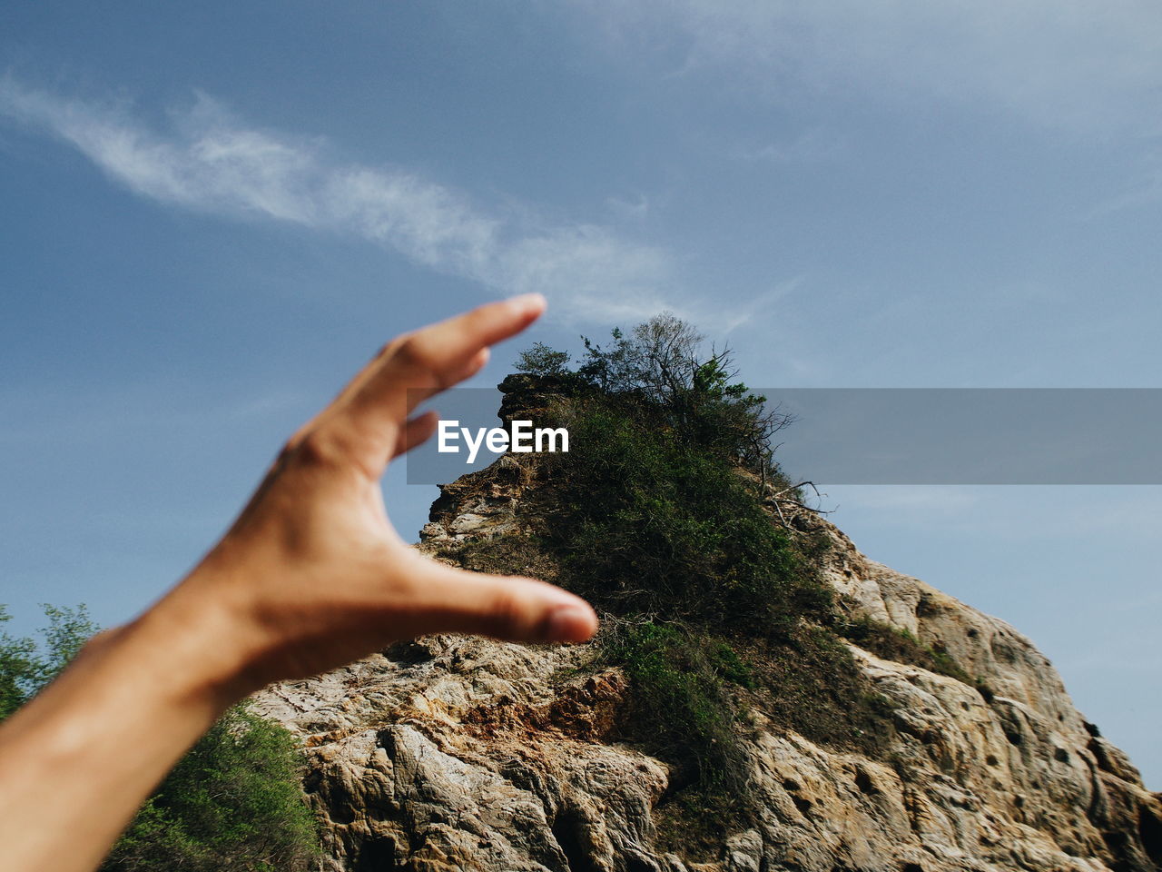 Low angle view of hand against sky