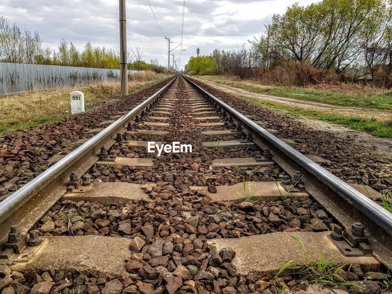 Surface level of railroad tracks against sky