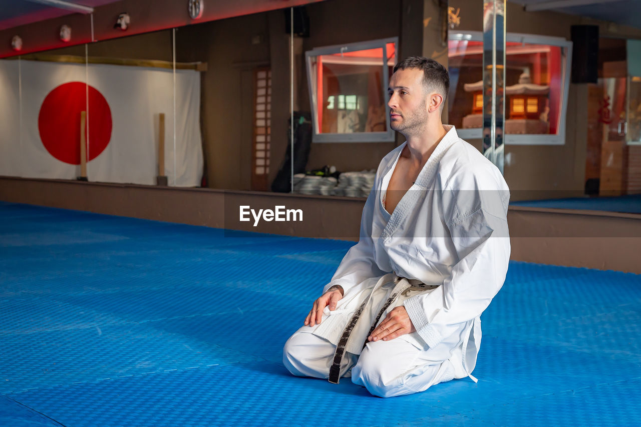 Karate man with traditional japanese sitting posture on tatami