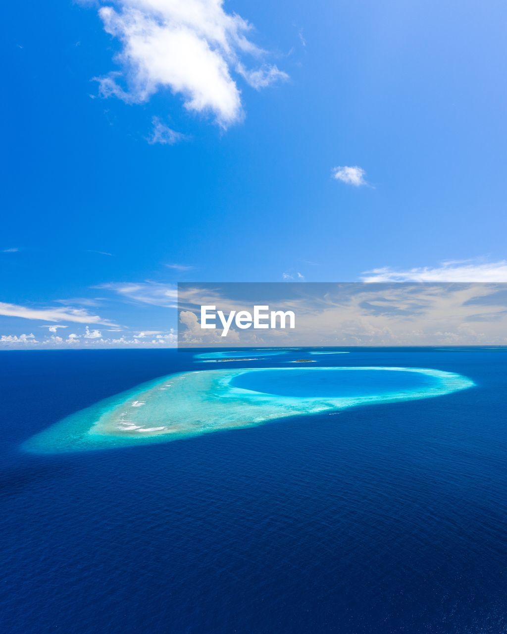 Scenic view of sea against blue sky