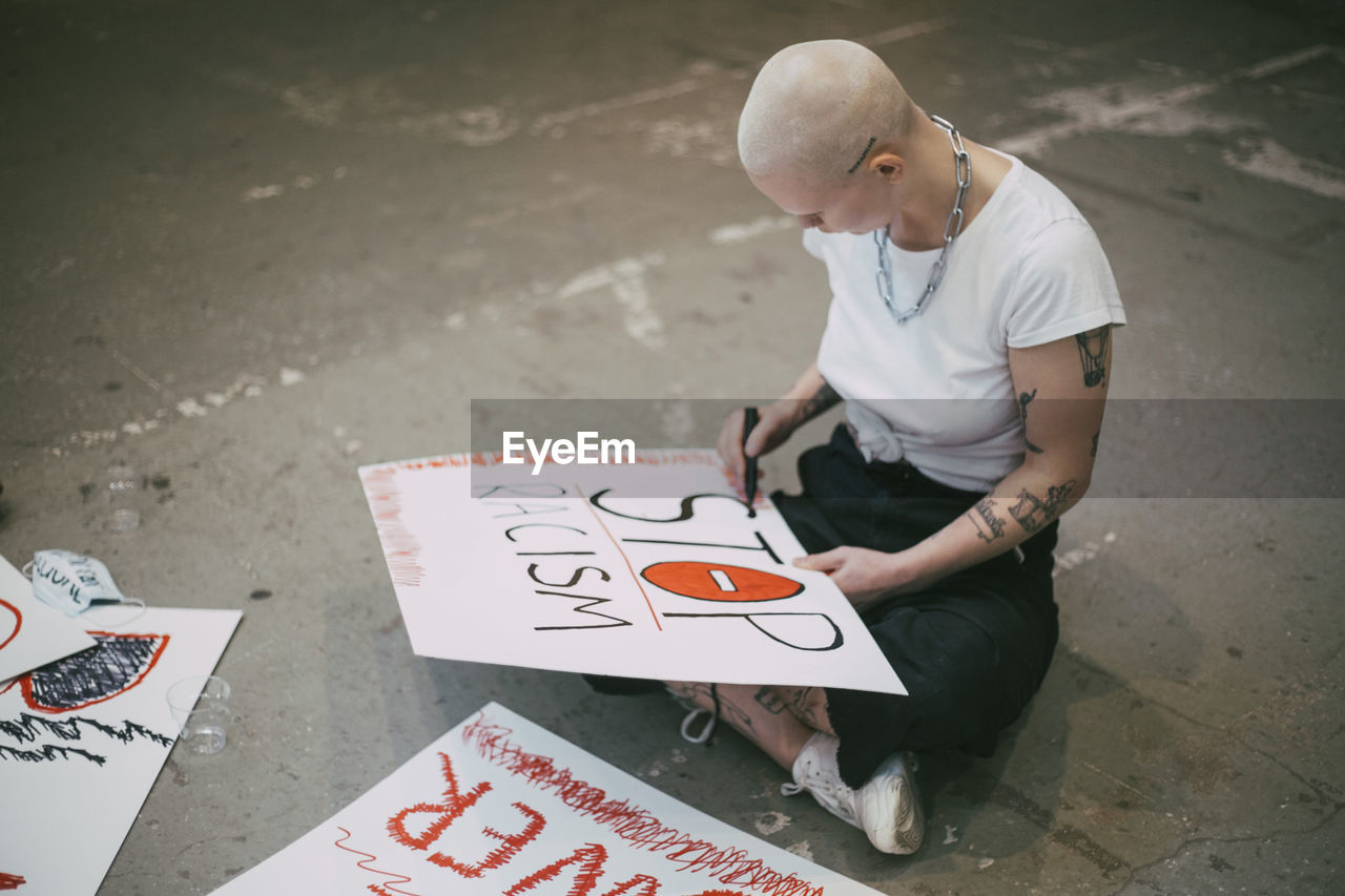 Female activist preparing stop racism signboard