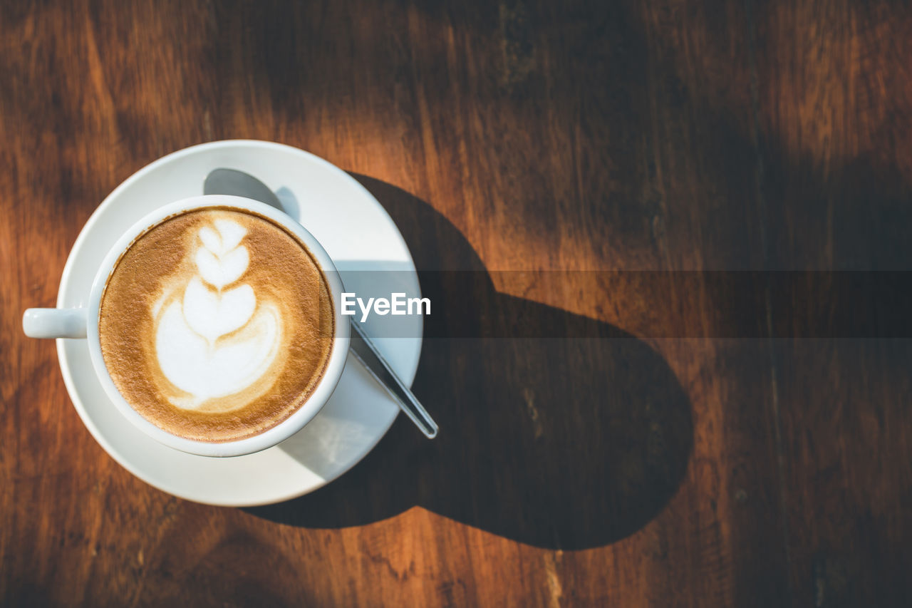 High angle view of coffee on wooden table