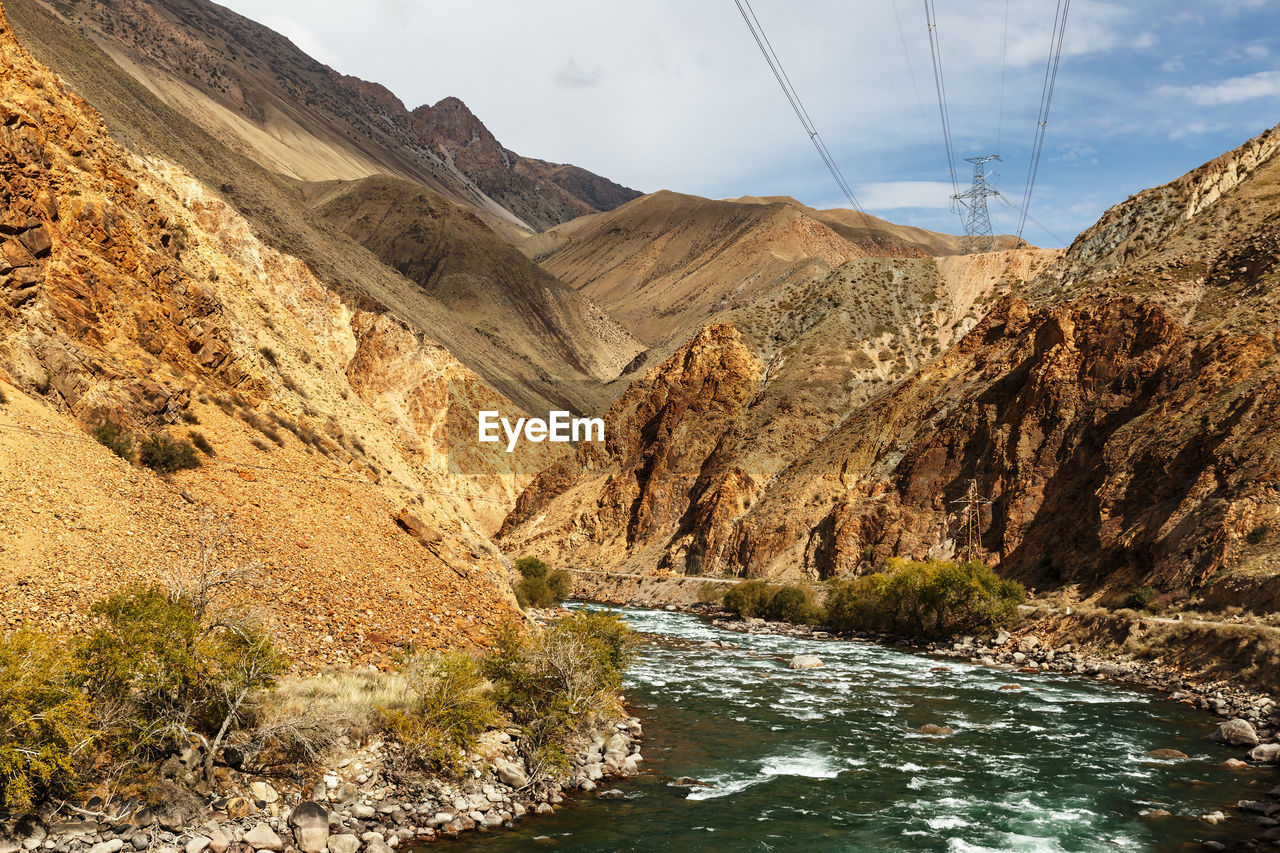 Mountain river and power lines. kokemeren river in naryn region of kyrgyzstan.