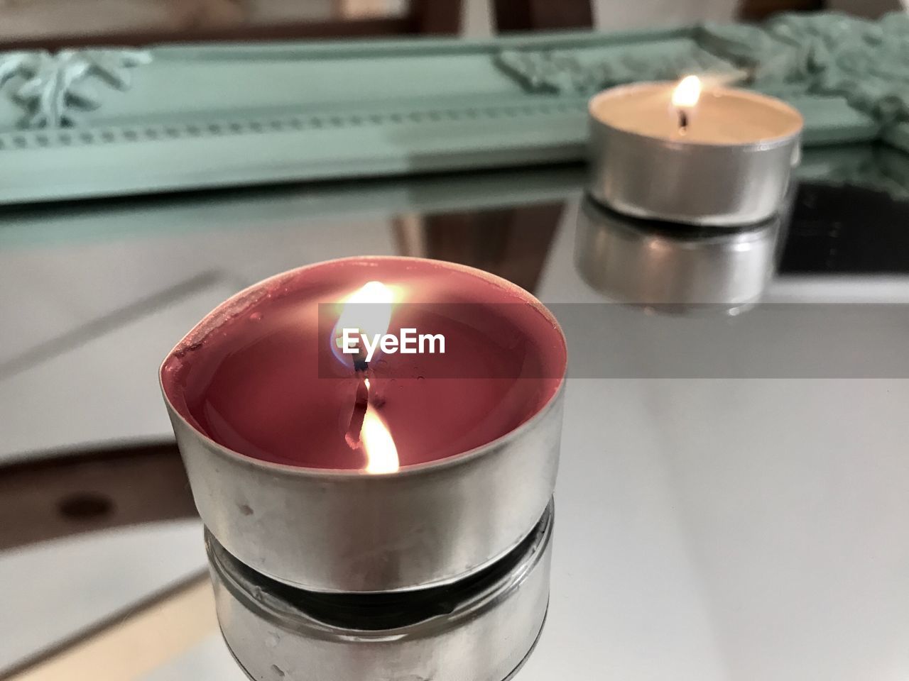 HIGH ANGLE VIEW OF TEA LIGHT CANDLE ON TABLE