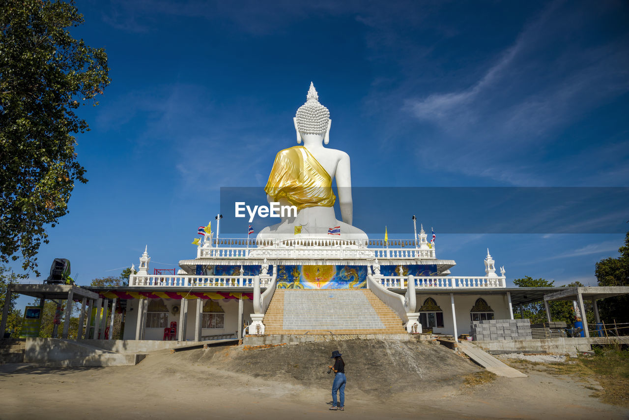 Statue of temple against cloudy sky