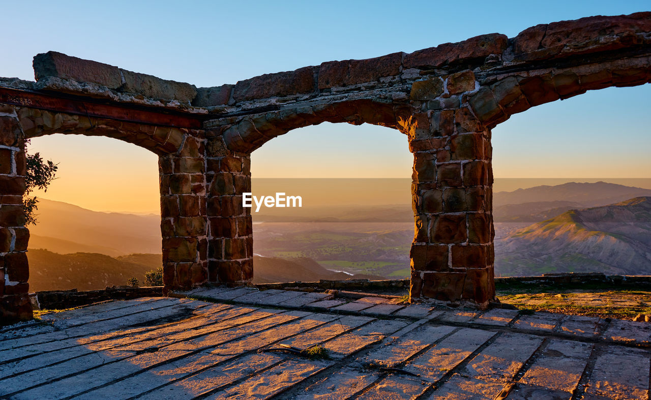 View of old ruin against sky during sunset