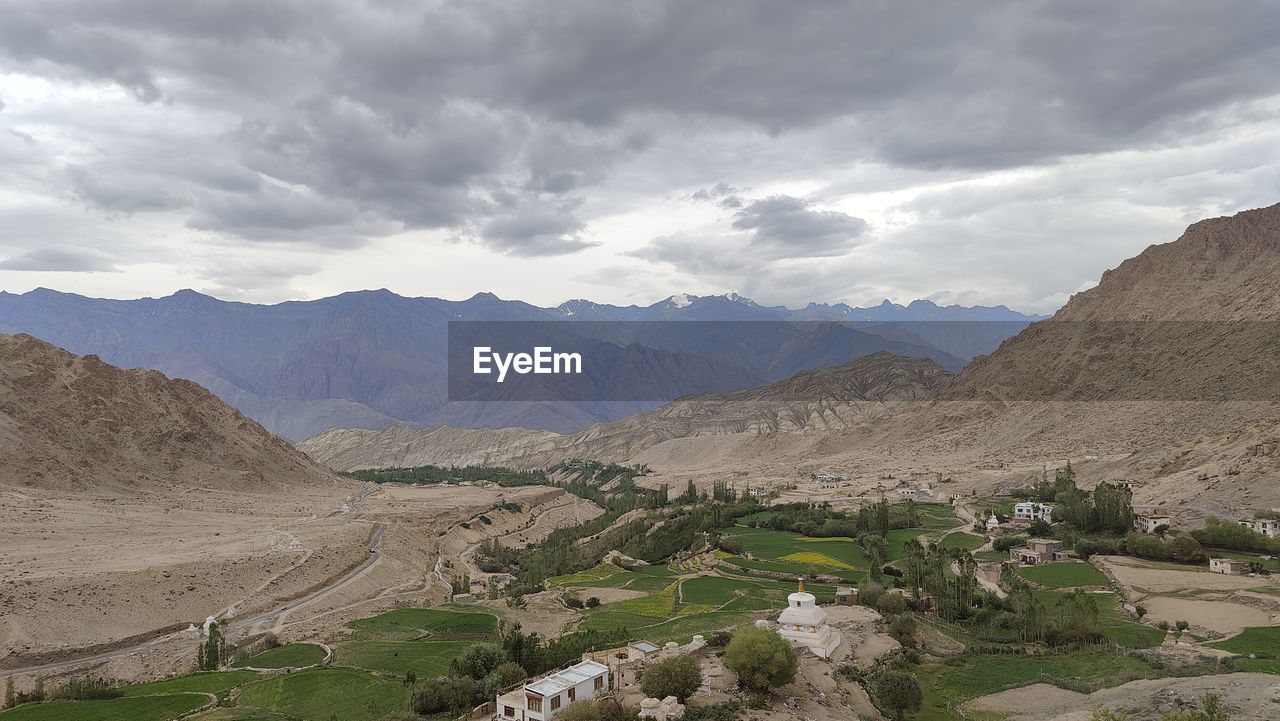 landscape, environment, mountain, scenics - nature, valley, mountain range, land, sky, cloud, nature, beauty in nature, plateau, travel, wadi, travel destinations, architecture, no people, non-urban scene, building, tranquility, plant, outdoors, religion, rural scene, overcast, agriculture, desert, tourism, rock, tranquil scene, history, mountain pass, panoramic, geology, climate, social issues, day, ridge, the past, arid climate, village, ancient, semi-arid, tree, road, remote, dramatic sky