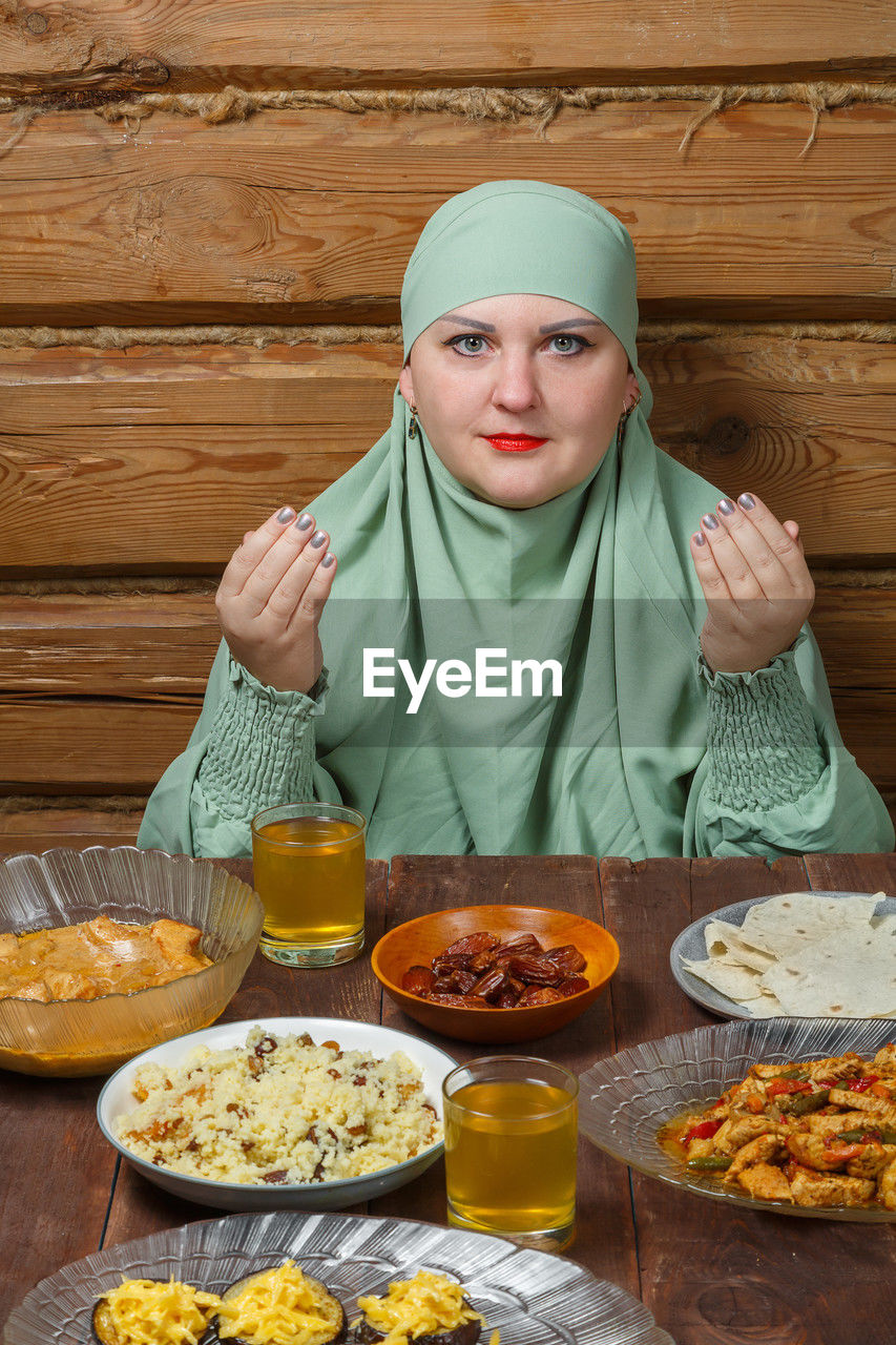 portrait of young woman having food on table