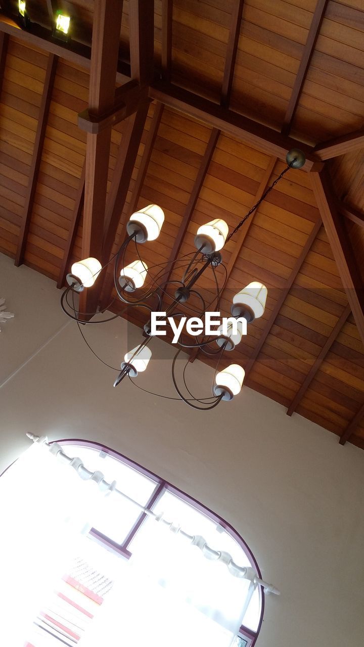 LOW ANGLE VIEW OF ILLUMINATED CEILING LIGHTS