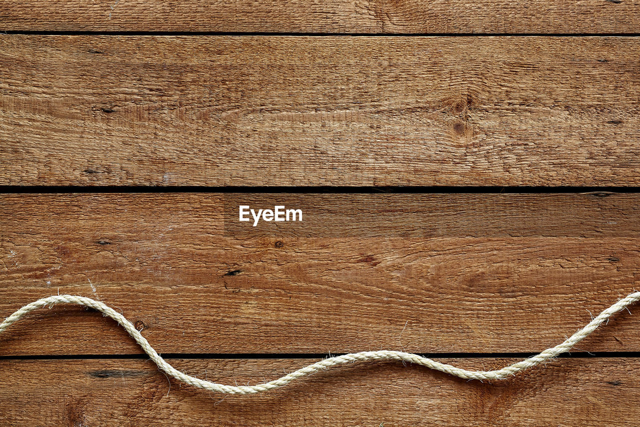 High angle view of string on wooden table