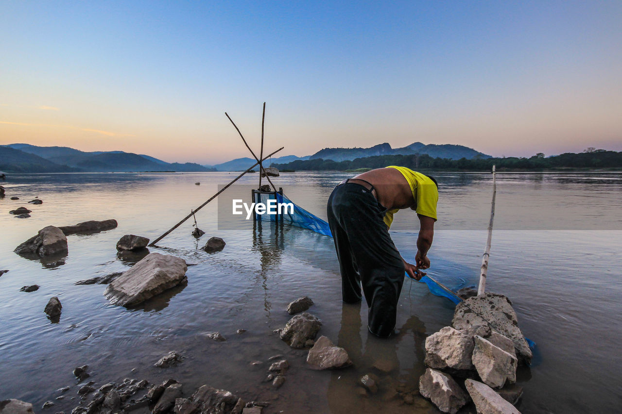 MAN FISHING IN SEA