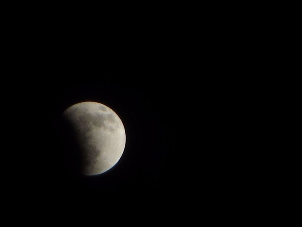 VIEW OF MOON OVER BLACK BACKGROUND