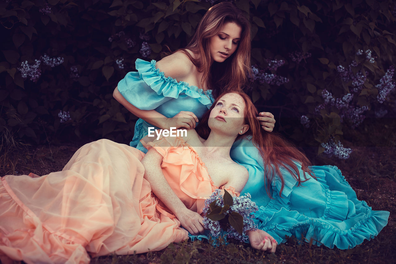 High angle view of young women sitting on grass