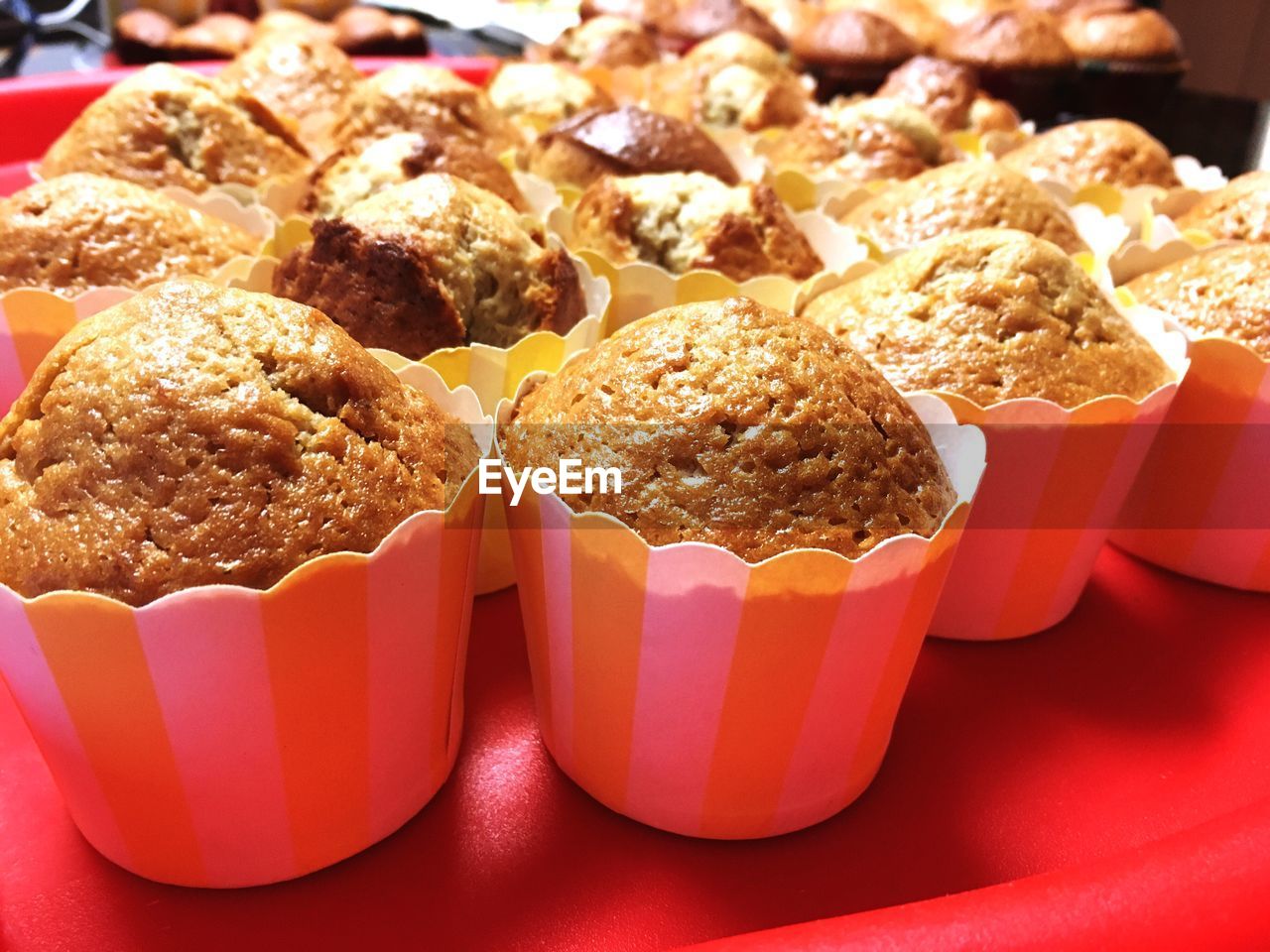 Close-up of cupcake on red table