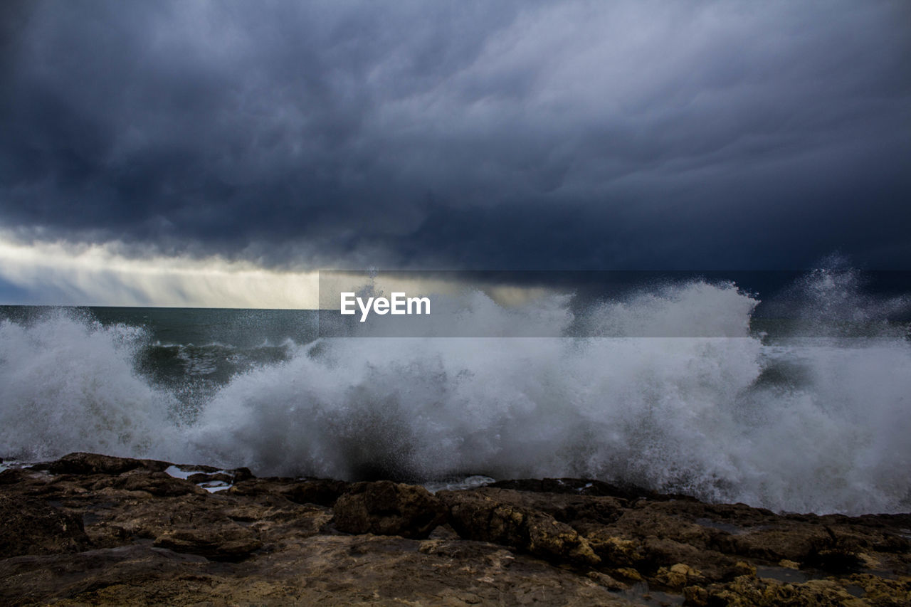 View of waves breaking against sky