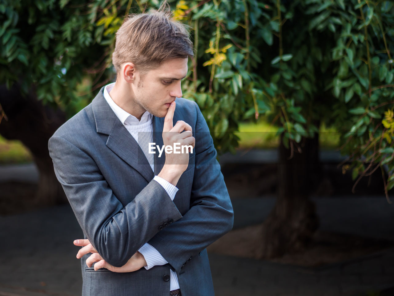 Close-up of businessman standing at park during autumn