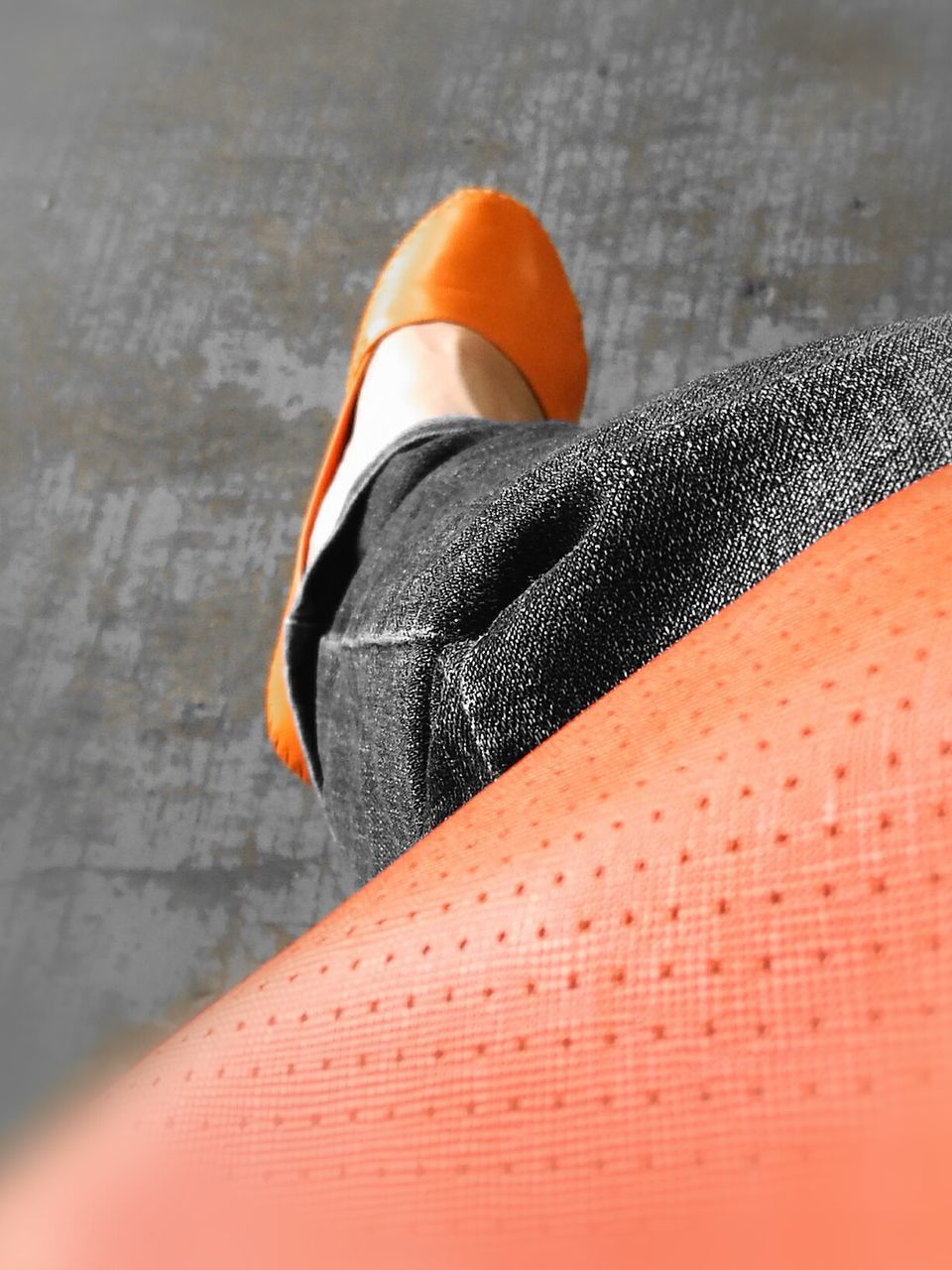 CLOSE-UP OF MAN ON TABLE WITH ORANGE