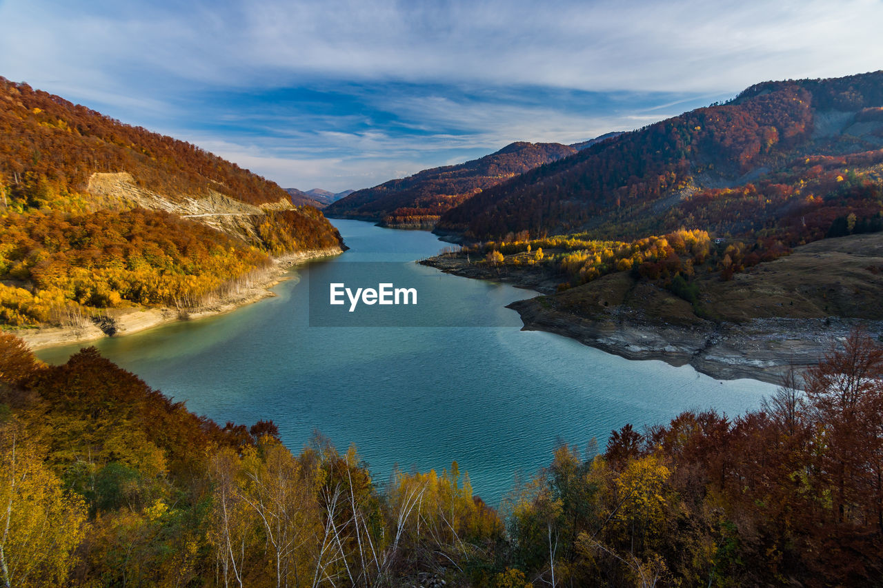 Scenic view of lake and mountains against sky during autumn