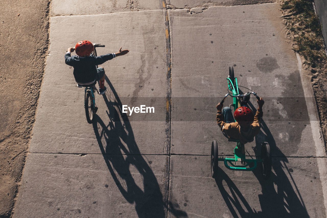 HIGH ANGLE VIEW OF BICYCLES ON STREET