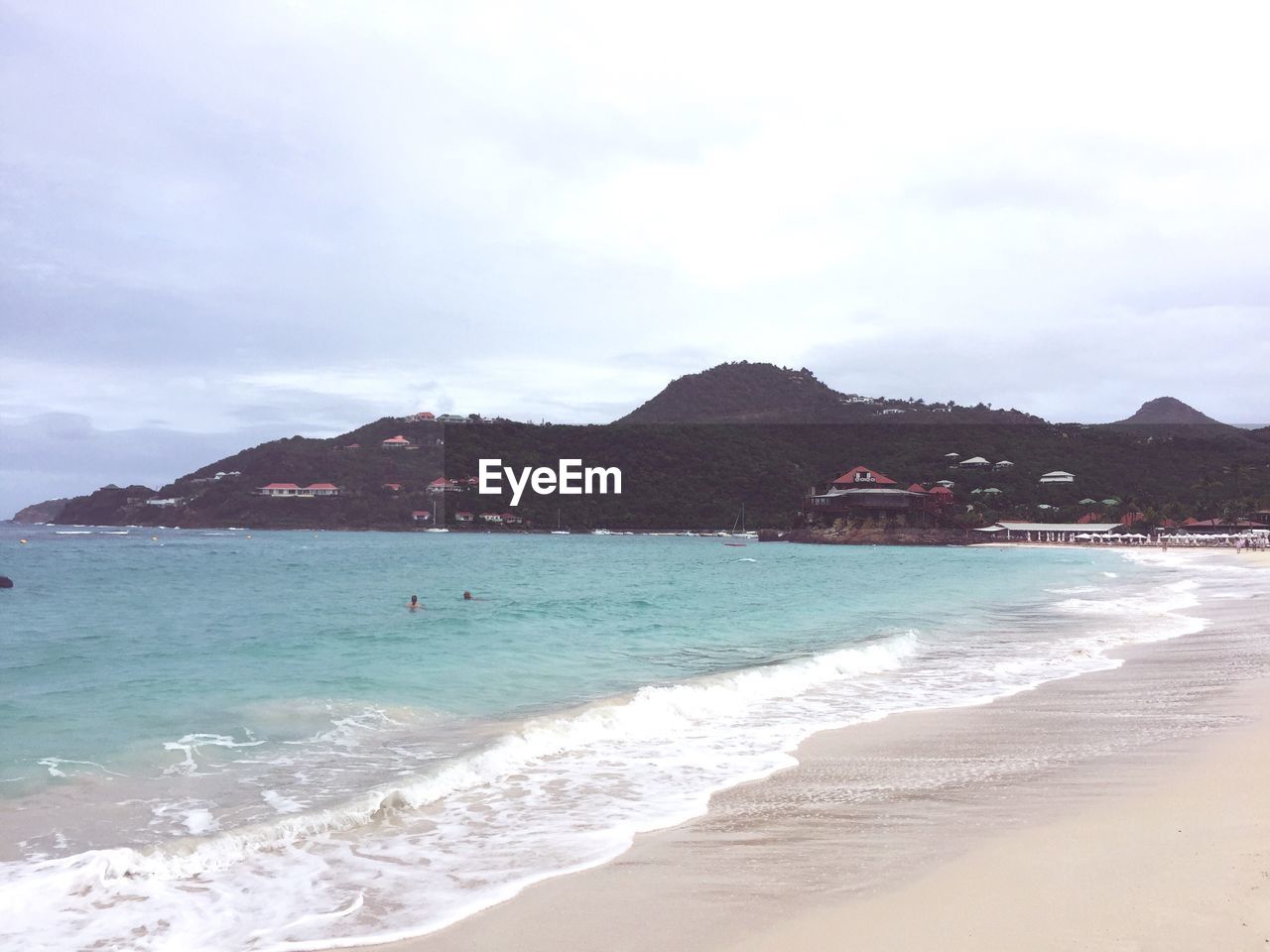 SCENIC VIEW OF SEA WITH MOUNTAIN IN BACKGROUND