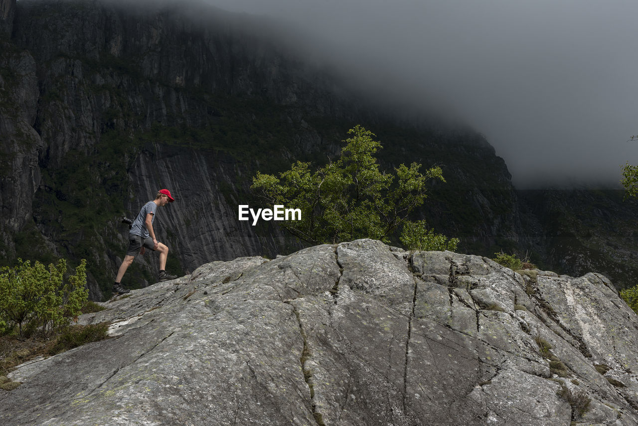 rear view of man standing on rock