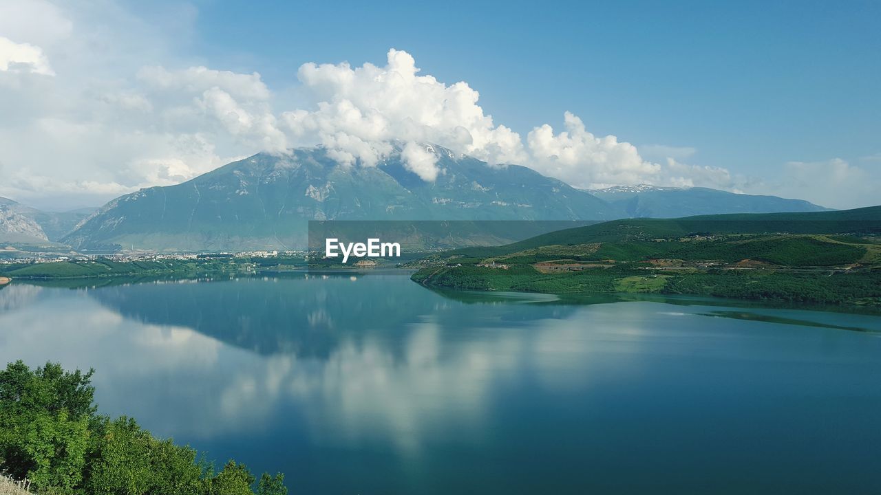 Scenic view of lake and mountains against sky