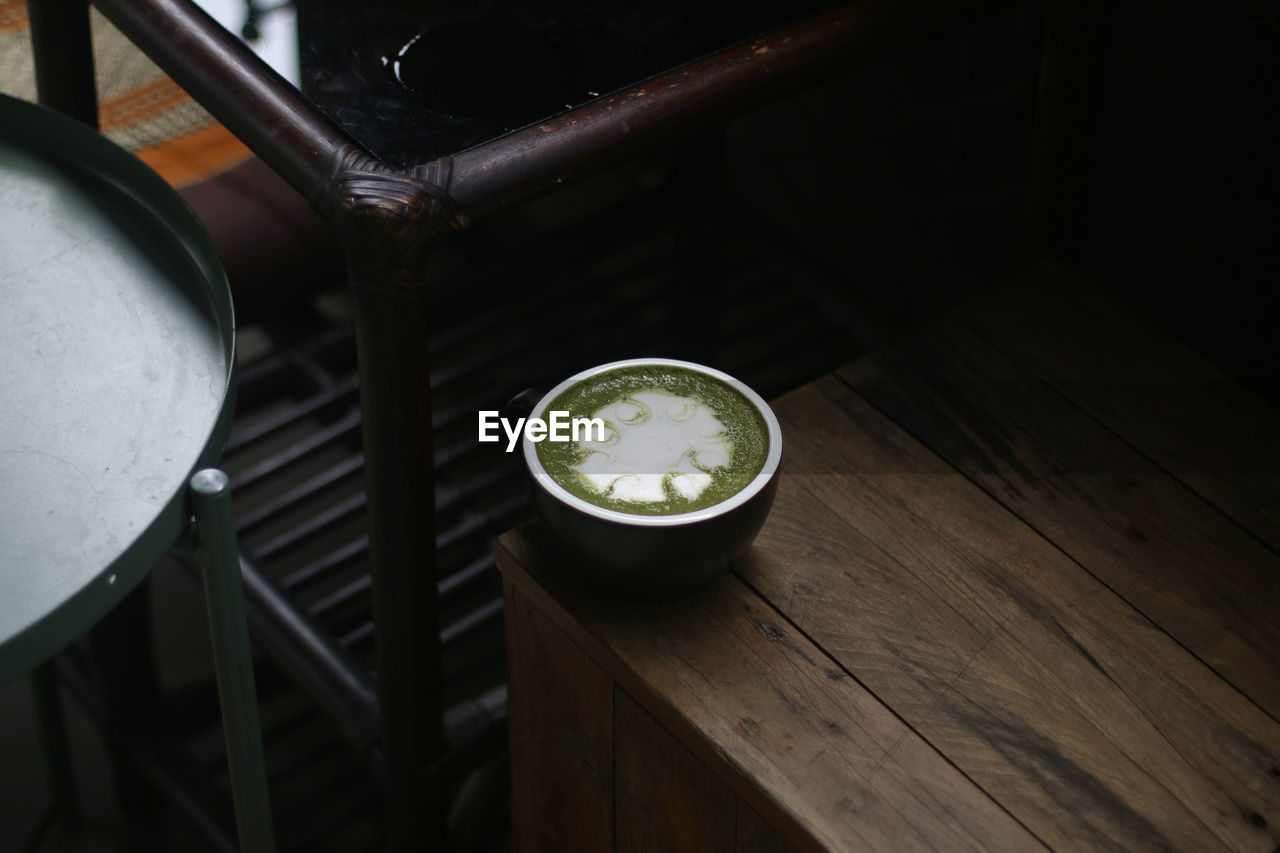 high angle view of metallic container on wooden table