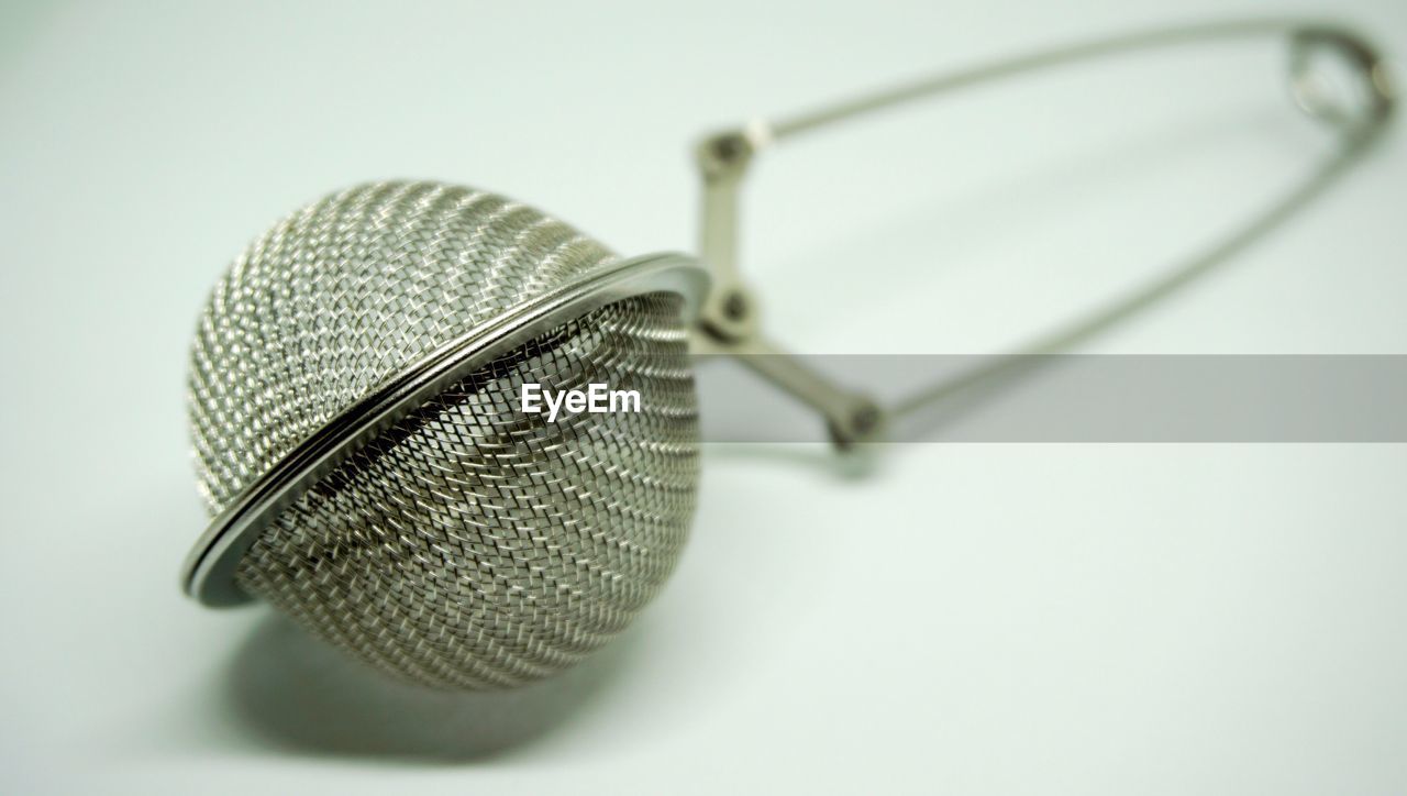 Close-up of tea strainer on table