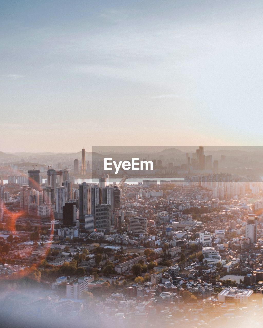 Aerial view of cityscape against sky during sunset