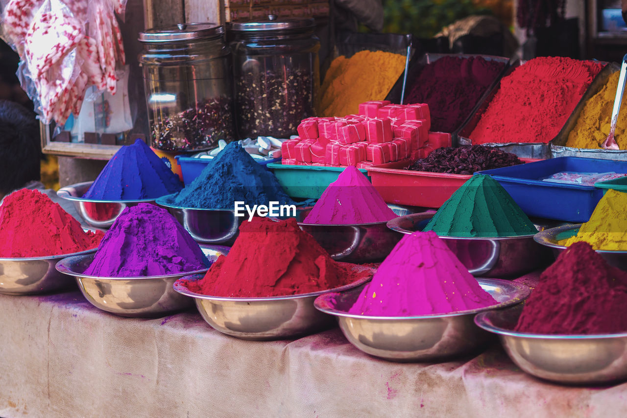 Multi colored powder paint for sale at market stall