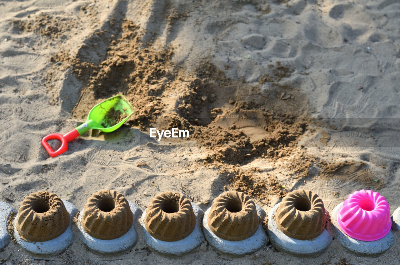 HIGH ANGLE VIEW OF TOYS AT BEACH