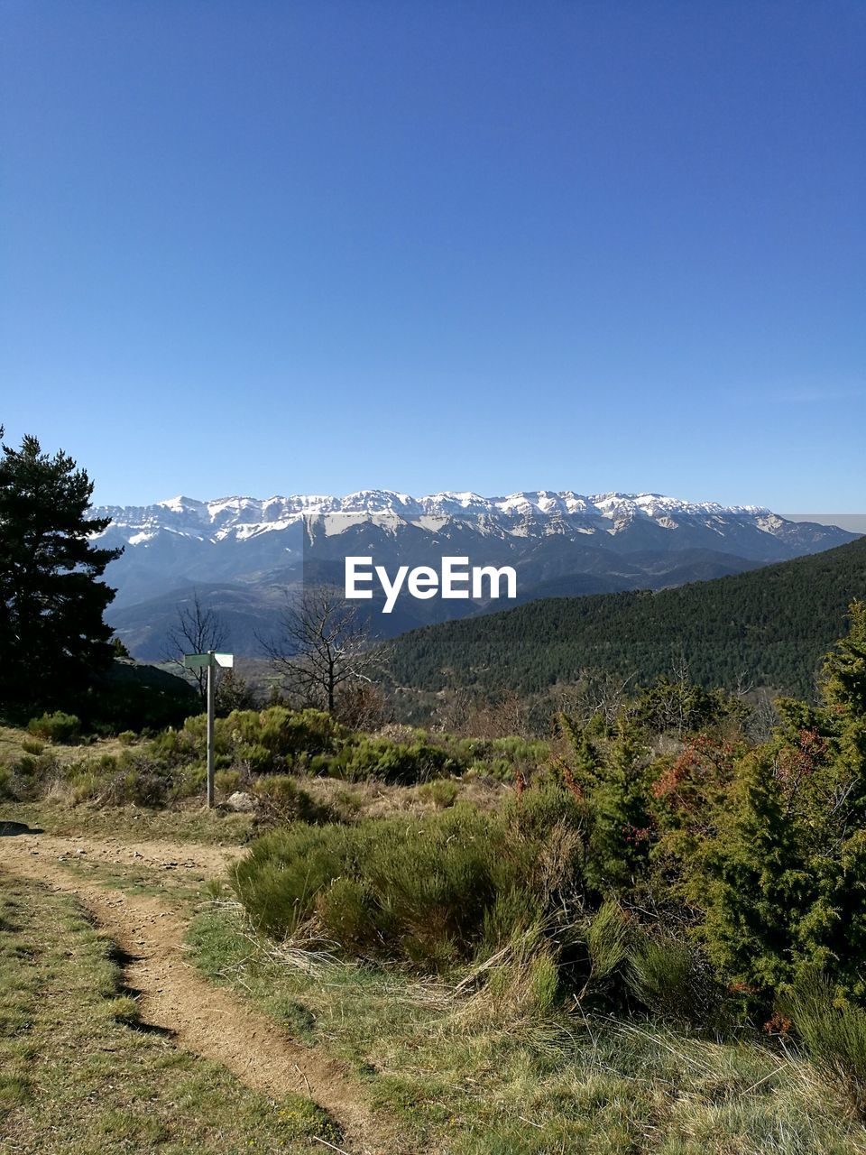 Scenic view of mountains against clear blue sky