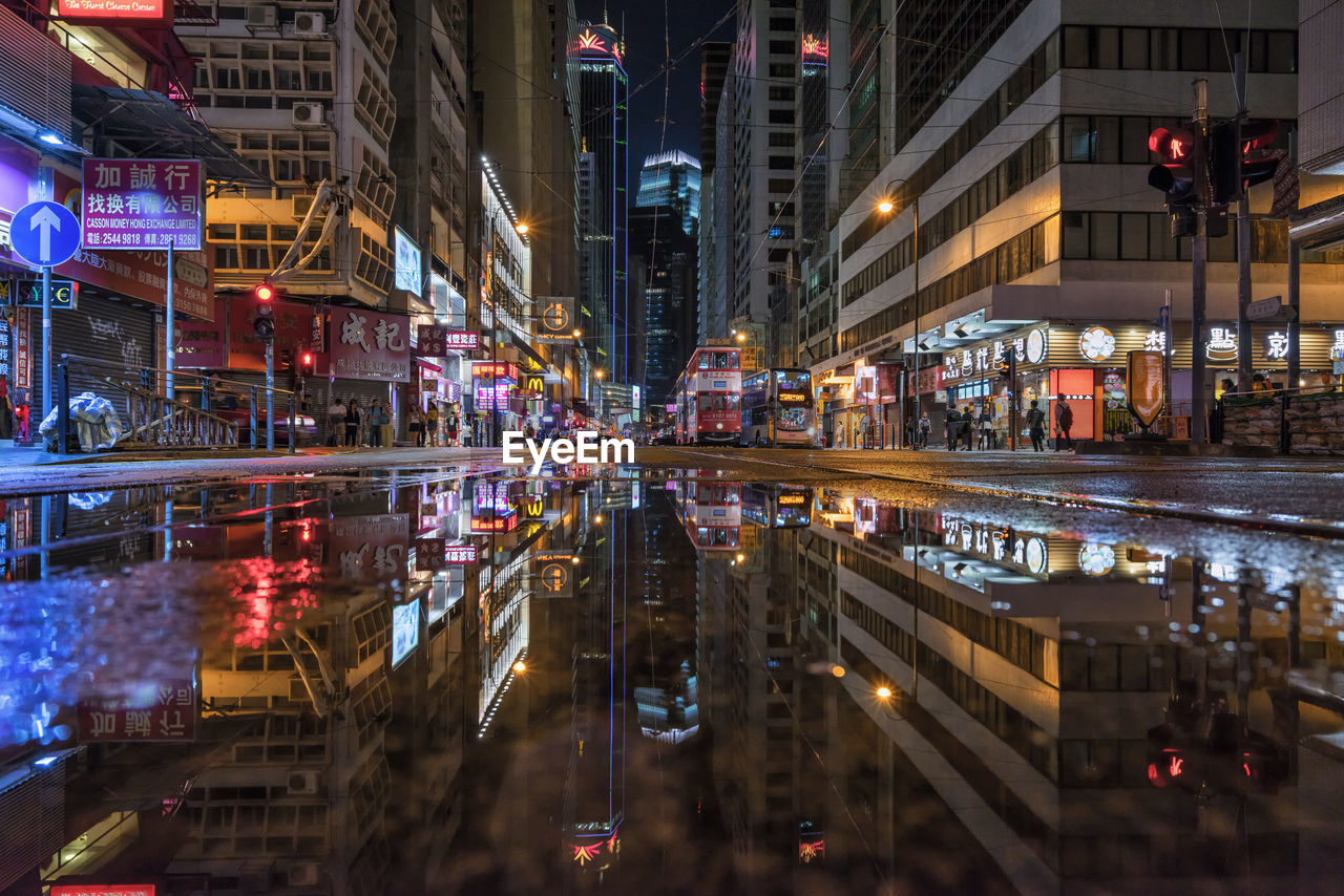 Illuminated city street and buildings at night