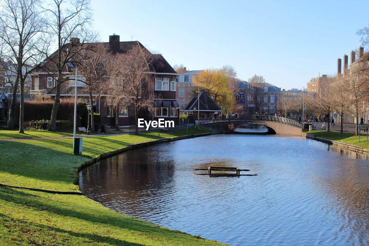 RIVER BY BUILDING AGAINST SKY