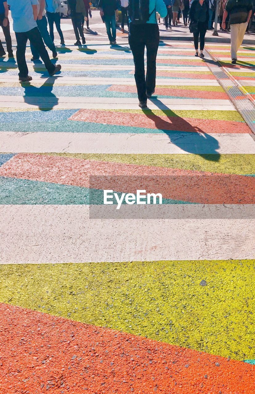 LOW SECTION OF PEOPLE WALKING OUTDOORS