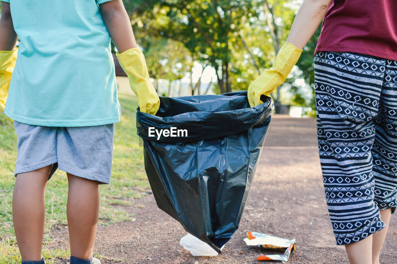 Low section of people collecting garbage