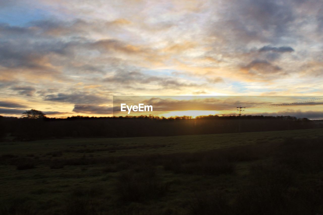 SCENIC VIEW OF SUNSET OVER LAND