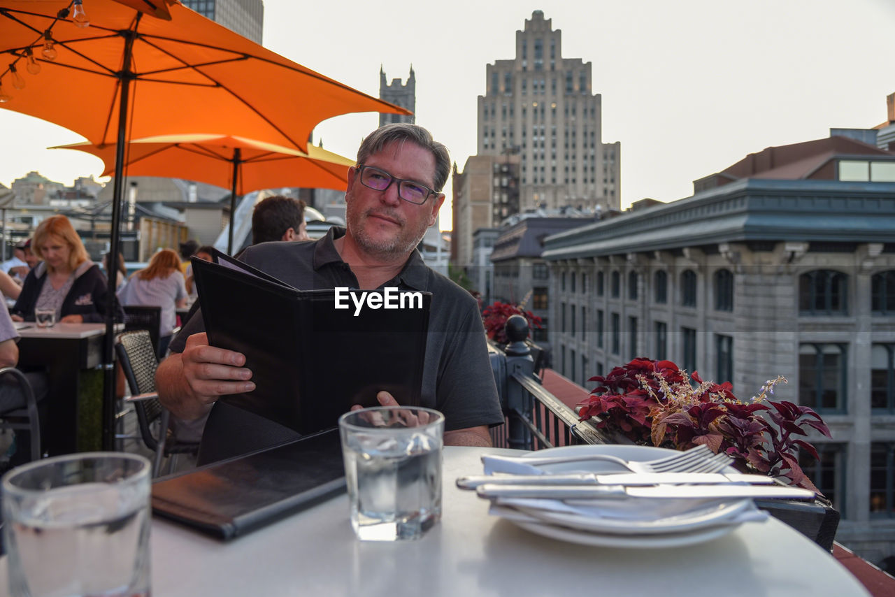 MAN SITTING IN RESTAURANT