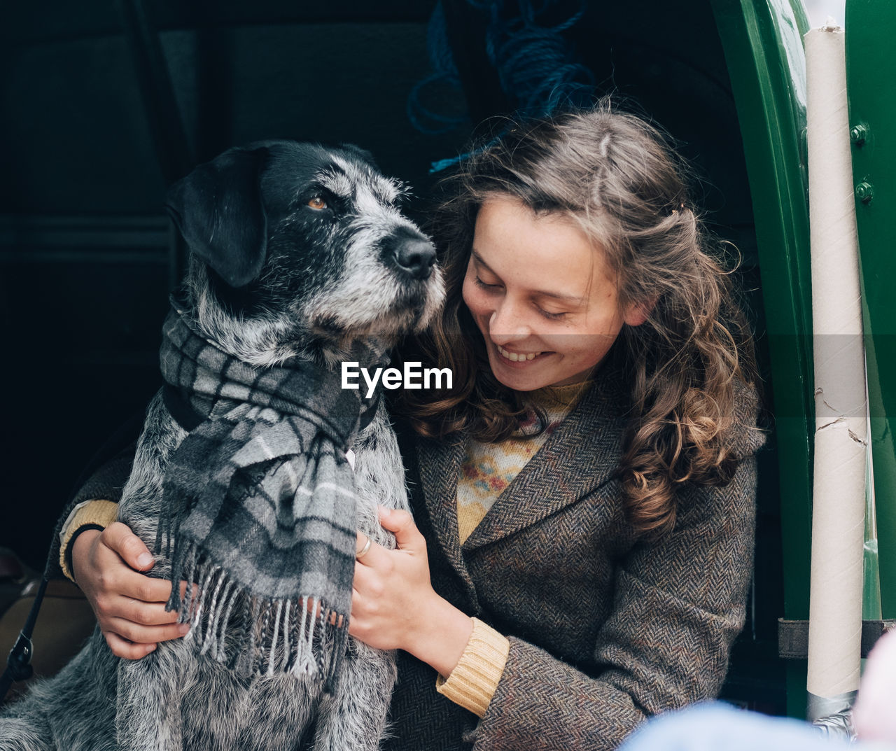 MIDSECTION OF WOMAN WITH DOG WITH MOUTH OPEN