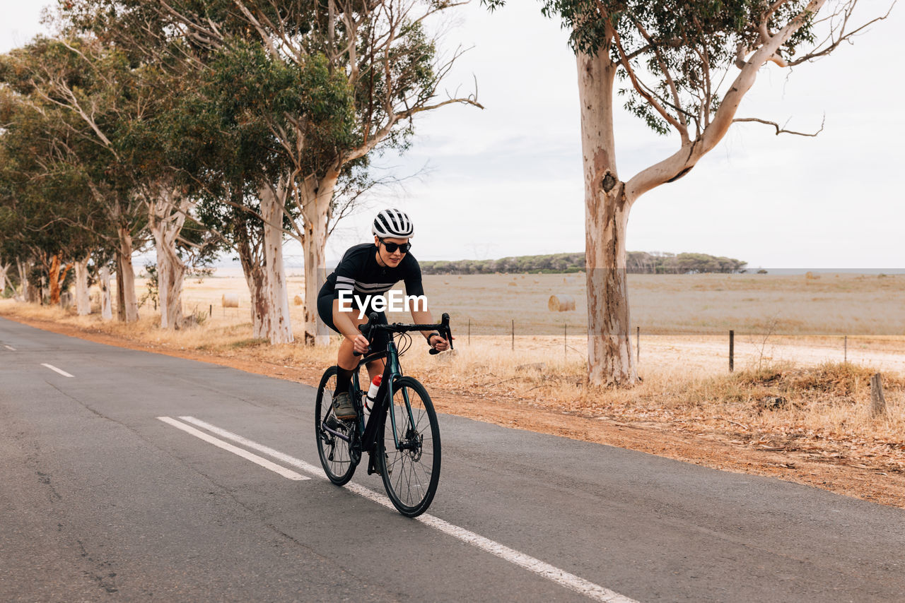 Woman riding bicycle on road