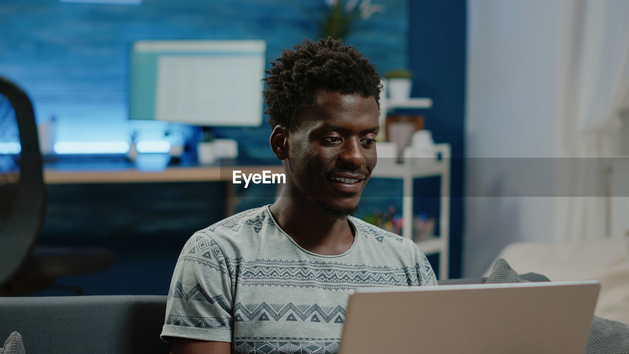 Young man using laptop at home