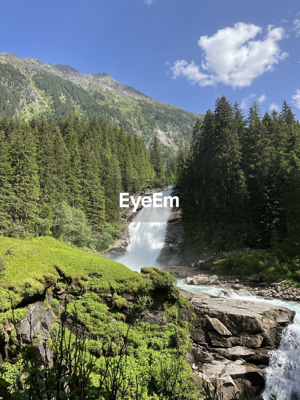 Scenic view of waterfall against sky