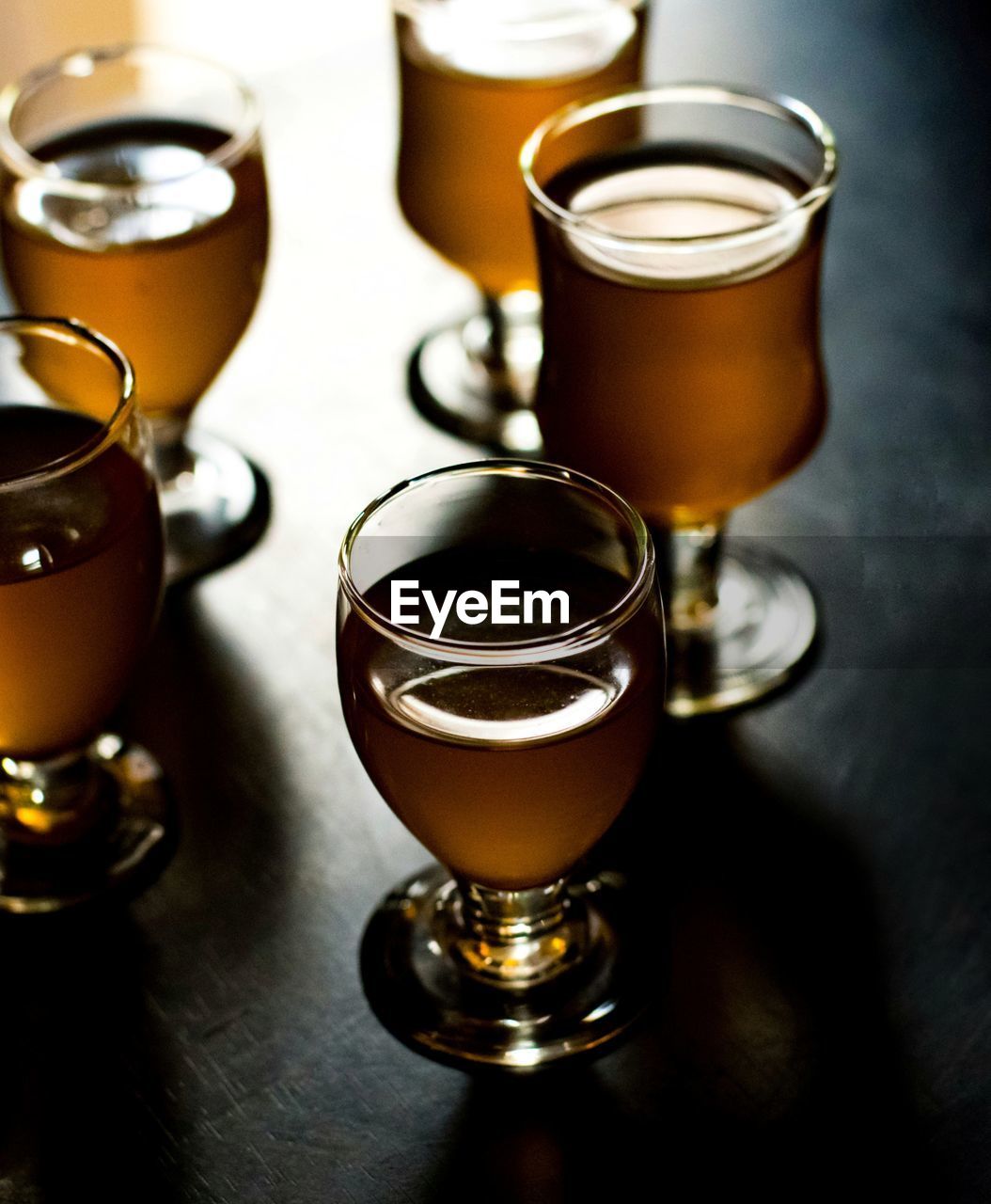CLOSE-UP OF BEER GLASSES ON TABLE