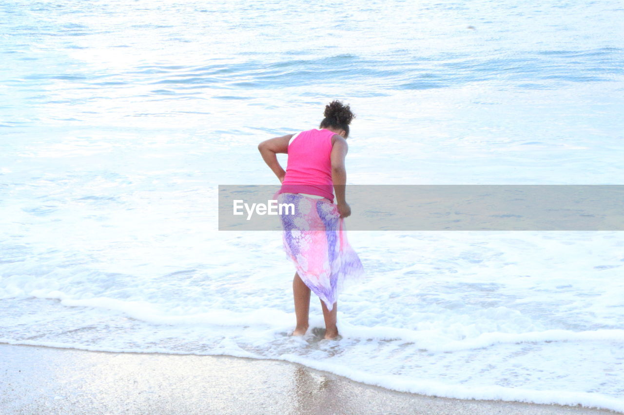 WOMAN STANDING ON SHORE