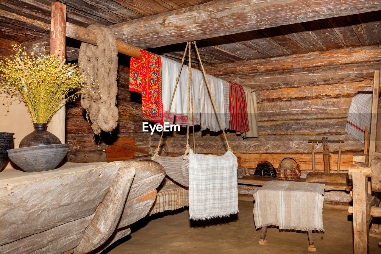 room, wood, indoors, no people, architecture, furniture, hanging, hut, interior design, seat, cottage, table, chair, nature, built structure, home, textile, rustic, log cabin, home interior, domestic room, plant, roof, house, day, building, decoration