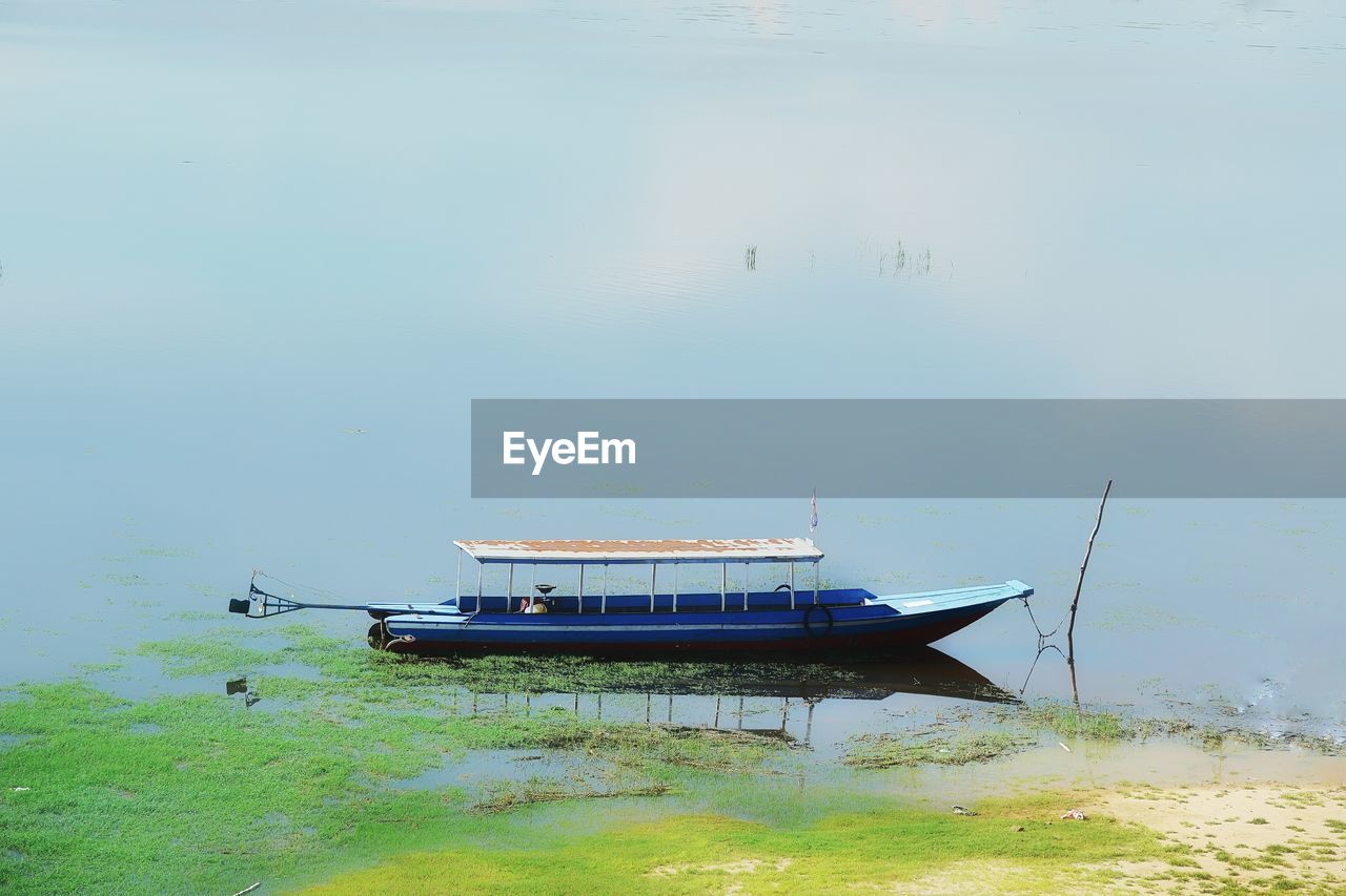 BOATS IN THE LAKE WITH REFLECTION OF CLOUDS