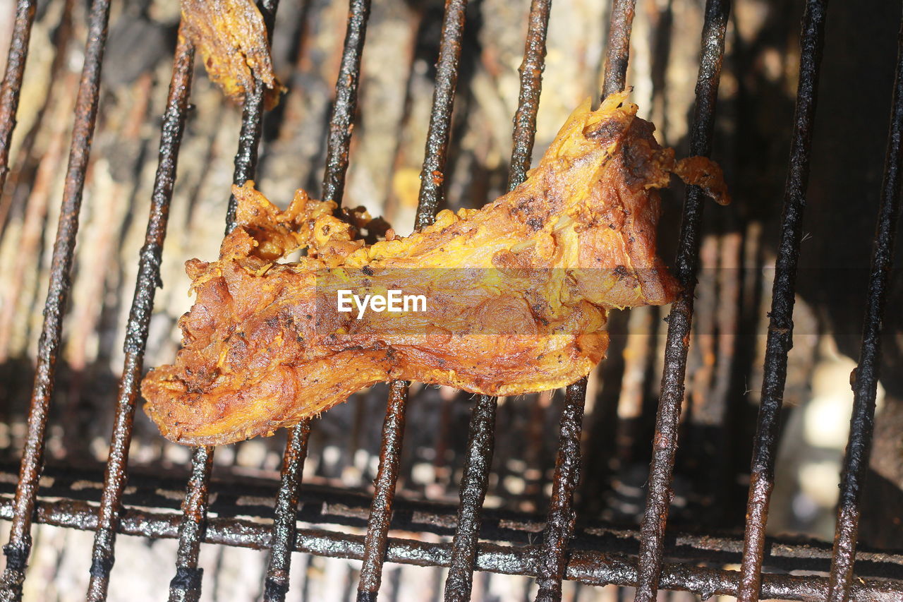 CLOSE-UP OF MEAT ON BARBECUE