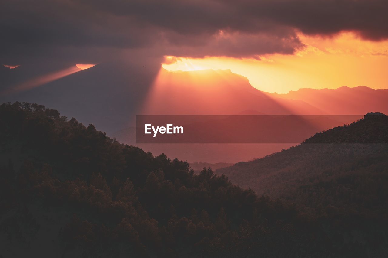 Scenic view of mountains against sky during sunset