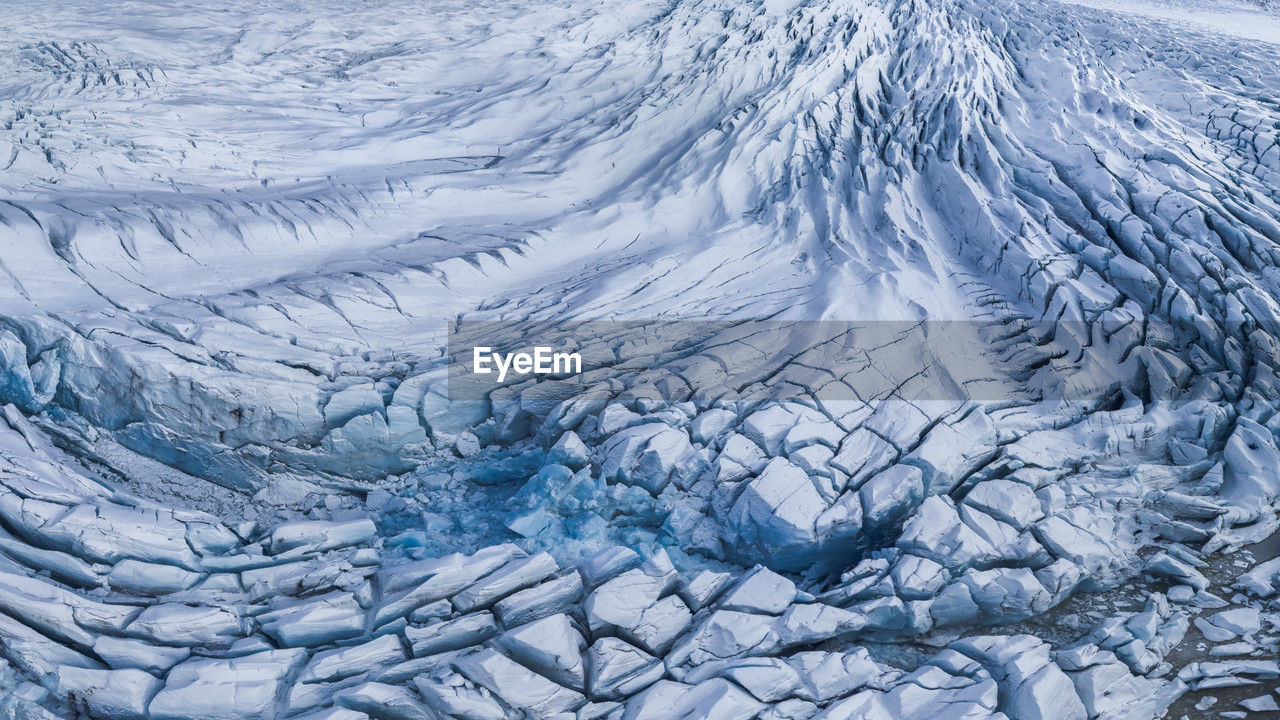 From above rough surface of vatnajokull glacier with cracks in wild volcanic terrain as abstract background